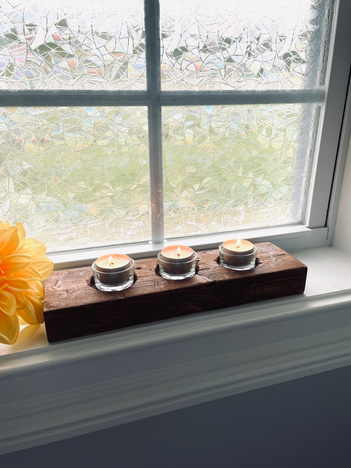 wood candle holder by window