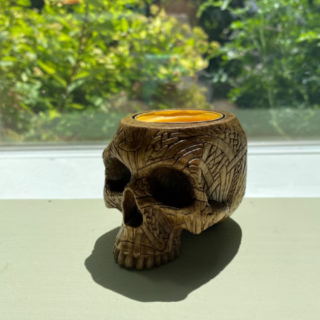 brown wooden carved skull closeup side angle view skull candle holders